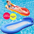 Woman on a colorful inflatable pool float with a blue inflatable lounge in the foreground, set against a pool background.